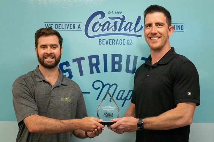 Robert Parker (left), senior project manager at Cape Fear Solar Systems presenting award to Brian Rector (right), CFO at Coastal Beverage Company for their solar project.