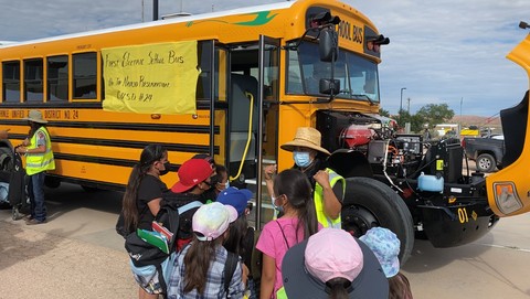 Blue Bird delivered its first electric school bus to Chinle Unified School District in Arizona, the largest school district in the Navajo Nation. Zero-emission transportation helps improve student and community health. Here, a “transporter of future Navajo leaders” (Chinle USD bus driver) provides an orientation to the functionality and benefits of the EV for students and community members at the debut appearance of the first EV school bus on the Navajo reservation. (Image provided by Chinle Unified School District)