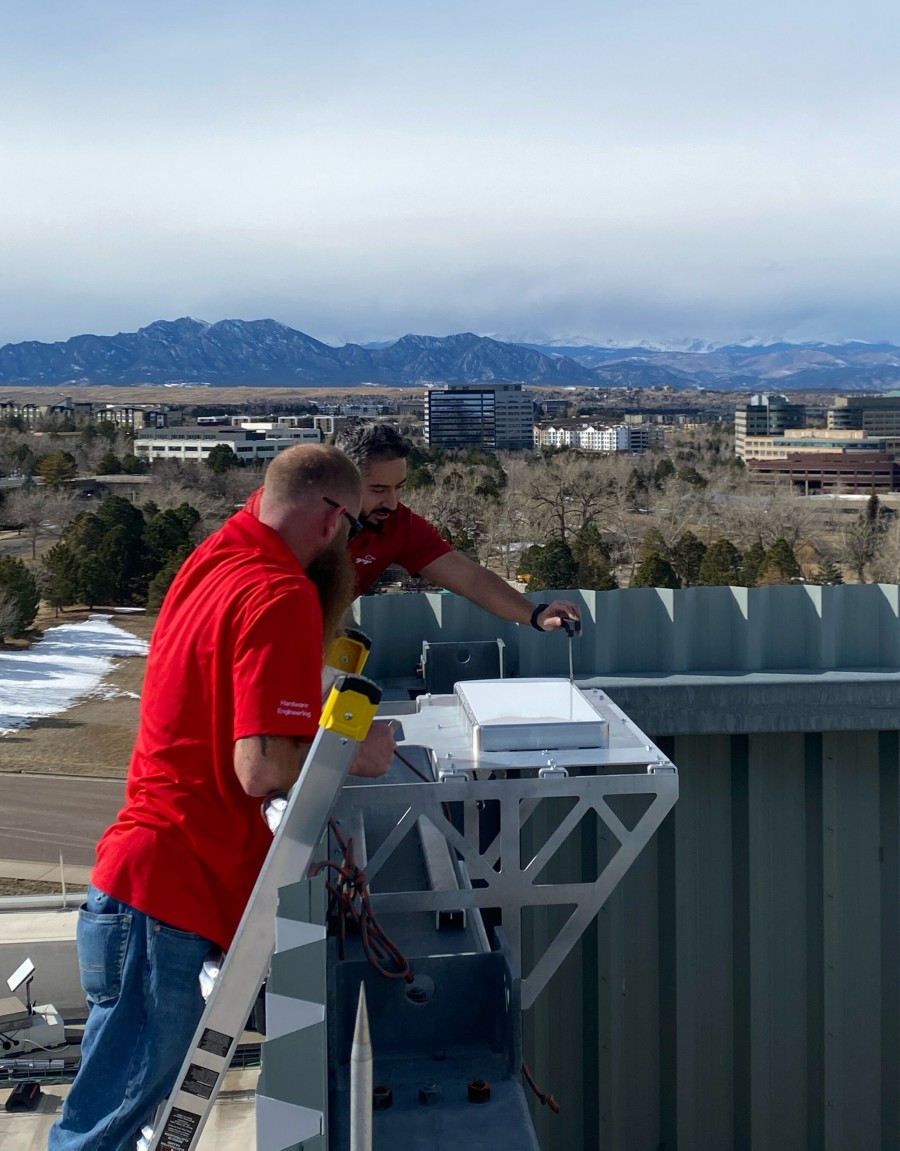 Technicians install the Gogo Galileo HDX antenna prototype now being used for initial testing on the roof of Gogo's headquarters in Broomfield, Colorado.